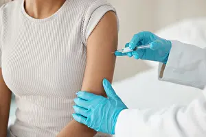 Examination Prints: Hands, doctor and needle with patient at clinic for vaccine injection