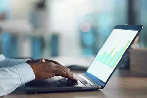 Analysis Prints: Hands, marketing and typing on laptop for graphs