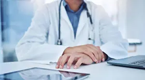 Surgery Prints: Hands, tablet and healthcare with a doctor at a desk in the hospital for medicine