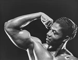 Bodybuilder Prints: Handsome Black Bodybuilder Flexes Bicep c.1957