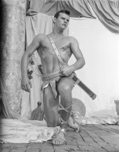 Bodybuilder Prints: Handsome Roman Gladiator Poses Outdoors c.1961