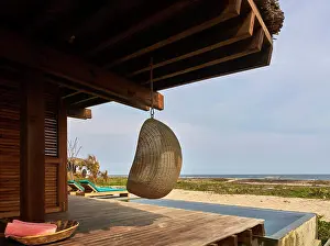 General View Prints: Hanging wicker chair with view from pool to ocean