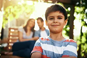 Backyard Prints: Happy boy, portrait and confidence with parents for childhood