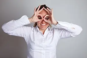 Outlook Prints: Happy business woman making circles with her fingers around her eyes