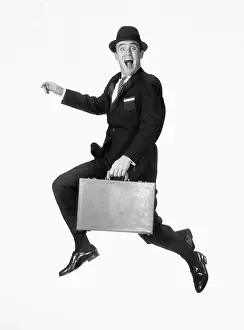 Exuberant Prints: Happy businessman jumping with briefcase - vintage black and white photo