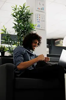 Report Prints: Happy executive manager celebrating successful product sales while working in start up business office