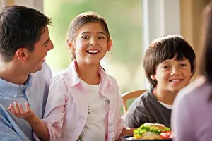 30 To 35 Years Prints: Happy family having fun eating at a dining table
