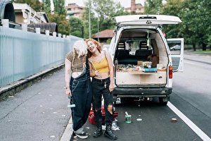 Lesbian Prints: Happy female couple, standing near their van