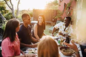 Communications Prints: Happy friends talking while enjoying food in dinner party