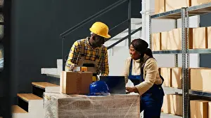 Logistics Prints: Happy group of employees laughing and checking boxes