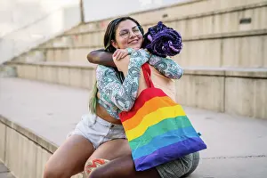 Mixed Prints: Happy interracial lesbian couple embracing