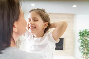 Fotografie Prints: Happy loving family. Mother and her daughter child girl playing and hugging Happy loving family