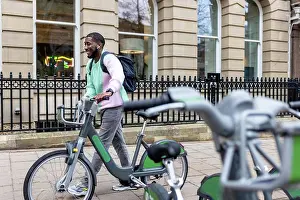 30 40 Prints: Happy man with electric bicycle walking on footpath