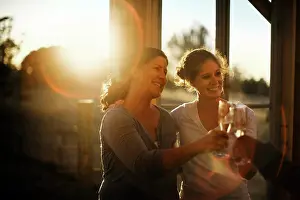 30 To 35 Years Prints: Happy middle aged couple make a toast in the building site of their new home