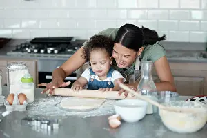 Flour Prints: Happy mother, kid and learning baking with rolling pin for dough