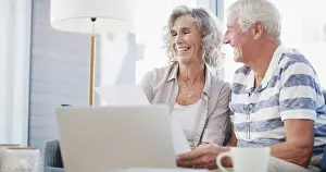 Paperwork Prints: Happy, old couple and laptop on sofa for paperwork