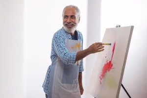 Smart Prints: A HAPPY OLD MAN LOOKING AWAY WHILE PAINTING