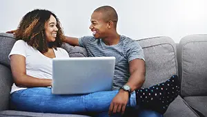 Dating Prints: Happy, relax and black couple on laptop online for watching movies