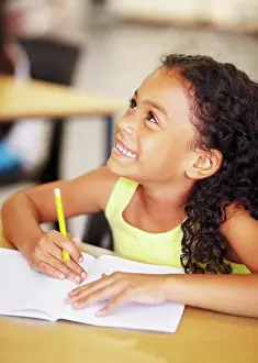 Scholar Prints: Happy, school and child writing in her book while listening to a lesson in the classroom