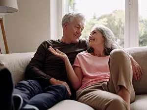 Best Prints: Happy senior couple relaxing on couch at home