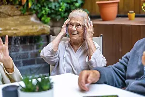 Hear Prints: Happy seniors using headphones and having fun in a nursing home