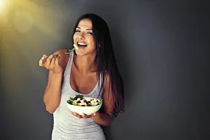Vegetables Prints: Happy woman is eating a salad, healthy food and nutrition