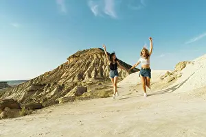 Holding Hands Prints: Happy women walking on hill
