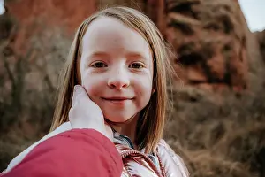 Trek Prints: Happy young girl smiling while mom touches face
