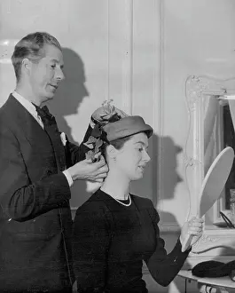 1952 Prints: Hats by Thaarup for Royal Tour -- Aage Thaarup suggest an Ivy embellishment to one of his clients at his London salon