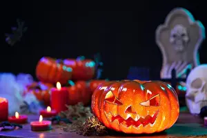 Haunted orange pumpking on halloween celebration table