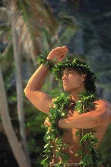 Hawaiian Prints: Hawaii, closeup of Kane (male) kahiko hula wearing maile leis, palms and mtns bkgd