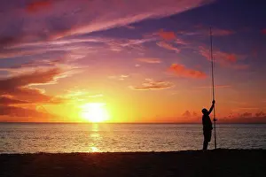 Sunburst Prints: Hawaii, Oahu, Fisherman holding his fishing line in the sunset