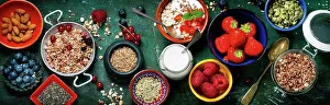 Ingredient Prints: Healthy breakfast of muesli, berries with yogurt and seeds on dark background - Healthy food