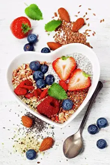Ingredient Prints: Healthy breakfast of muesli, berries with yogurt and seeds on white background - Healthy food