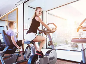 Weight Prints: Healthy happy couple training on a treadmill in a sport center