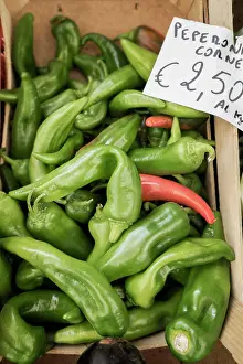 Consumerism Prints: Heap of green pepperoni chilli peppers for sale at market, Puglia, Italy