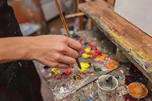 Life Styles Prints: High angle view of artist mixing paint in palette at studio