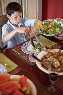 Knife Prints: High angle view of a boy sitting at a dining table