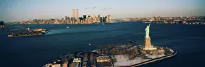 Downtown District Prints: High angle view of Ellis Island with the Statue of Liberty and the World Trade Center in Manhattan
