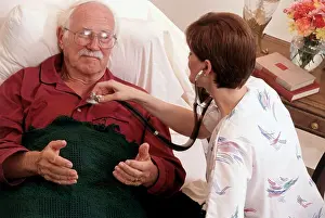 Bald Prints: High angle view of a female nurse examining a patient