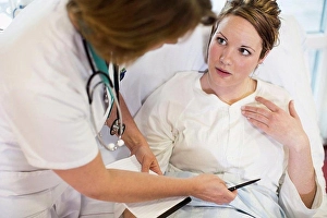 Patients Prints: High angle view of female patient communicating with doctor in hospital ward
