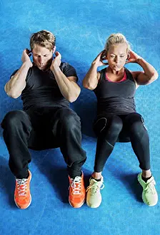 Front Views Prints: High angle view of friends doing sit-ups at gym