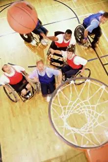 Handicapped Prints: High angle view of a group of mid adult men in wheelchairs playing basketball