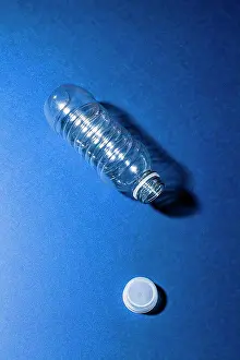Light Natural Phenomenon Prints: High angle view of empty plastic bottle on blue table