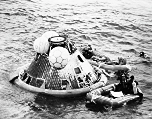 Oxygen Prints: High angle view of a rescue squad near a space capsule in the sea