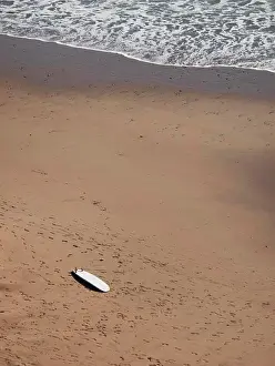 Sun Light Prints: High angle view of surfboard on sand at beach