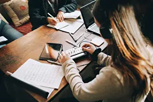 Instruction Prints: High angle view of teenage girl using audio equipment while doing homework at table in room
