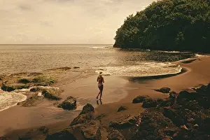 Society Prints: High angle view of a woman running on the beach, Tahiti, Society Islands, French Polynesia