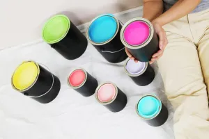 Assortment Prints: High angle view of a woman sitting with paint cans beside her