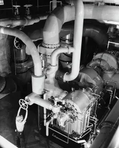 Turning Prints: High angle view of a worker working in an engine room of a steel rolling mill